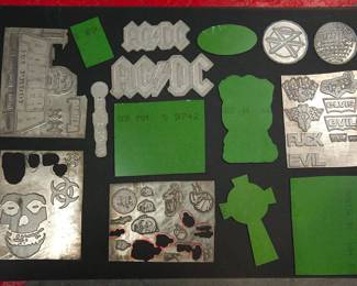 Front and back of metal plates used as models when The Alley made statuary products for many major rocks groups, including AC/DC, The Ramones, The Rolling Stones, Pantera, Garbage, and Dead Kennedys