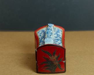 Side view of antique Chinese blue + white and red porcelain box