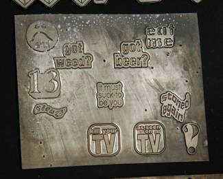 A different detail of metal plates used as models when The Alley made statuary products for many major rocks groups, reading "got weed?" "got beer?" "eat me" "kill your TV' and "stoned again"