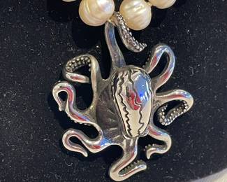 Detail of pearl beaded necklace with a sterling silver octopus pendant