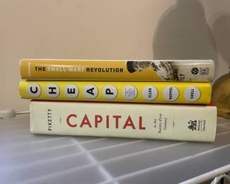 Book collection including: "The Small-Mart Revolution", "Cheap", and "Capital in the Twenty-First Century"