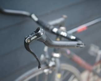 Handlebar brake detail of black Bianchi men's road bicycle with Syntace handlebars