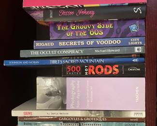 Book collection including: "African Designs from Traditional Sources", "Tattoo Art: CD ROM Book", "Tattoos", "Tattoo: Secrets of a Strange Art", "Tattoo Art & Design", "Tattoo Johnny", "The Groovy Side of the '60s", "Secrets of Voodoo", "The Occult Conspiracy", "Tibet's Sacred Mountain", "Hot Rods", "Photography from 1839 to today", "Skins", "Gargoyles & Grotesques", "Steampunk Sourcebooks", "Animal Vecor Designs", "Hawaiian Petroglyphs", "Capone: The Man and the Era"