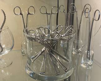 Set of crucible tongs, beakers, and assorted glassware