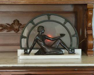 Art Deco bronze and marble lady in front of a clock lamp