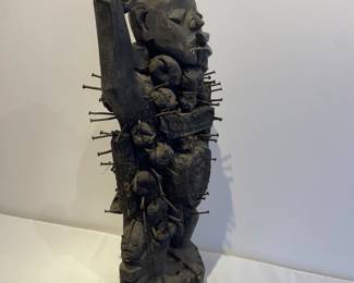 Side view of wood and nail African fetish sculpture