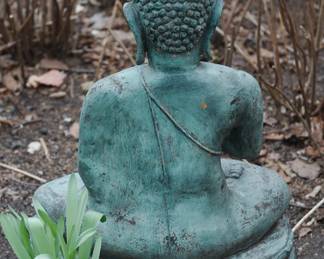 Back of metal meditating Buddha statue