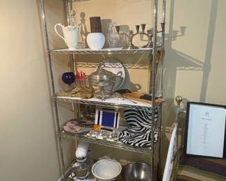 A display rack full of kitchen ware including mixing bowls and a white KitchenAid stand mixer