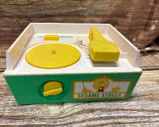 Vintage Fisher-Price Sesame Street music box record player, with records