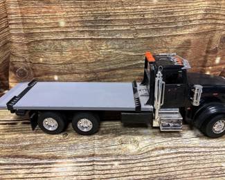 ERTL Case, peterbilt, battery operated plastic flatbed tow truck