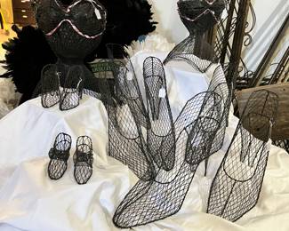 Whimsical black wire busts and high heel shoes planters