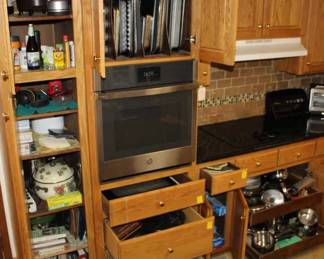 Kitchen Cabinets inside; cookbooks, pans, baking pans, etc