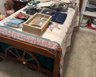Twin wagon wheel bed with box spring and mattress. Sweaters, pillows 
