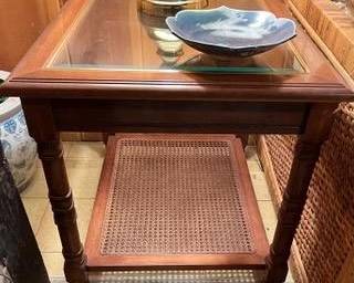 Wood and glass occasional table with caning, one of pair