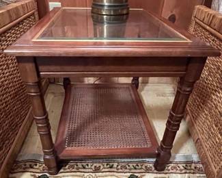 Wood and glass occasional table with caning, one of pair