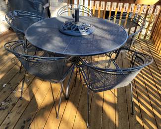 Large round patio table with six chairs (five pictured)