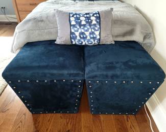 Two navy blue microsuede storage ottomans