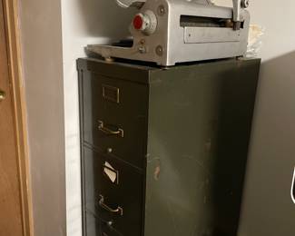 Old metal filing cabinet and commercial meat slicer