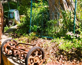 Iron Gate, old wheel barrow and mower blades