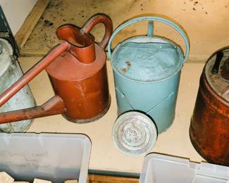 Tin watering cans and oil can