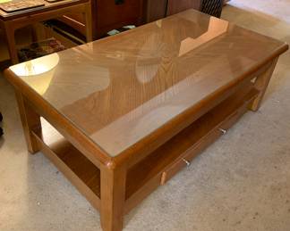 wood coffee table, glass top, pulls up to desk height
