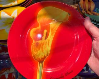 and middle shelf contains about two dozen plates made by Givenchy