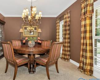 Dining room table with leaves around outside of table and 4 chairs