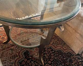 Round metal and glass-topped side table with lower-tier 