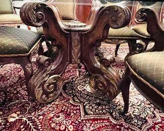 Another picture of the double-pedestal glass-topped dining table and dining chairs 