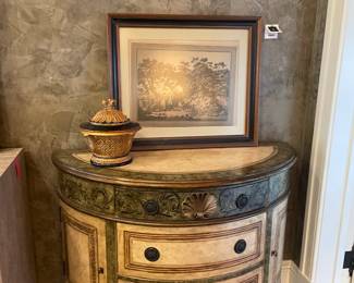 Demi-lune table with 3-drawers and side cabinets, framed print and gold and black urn