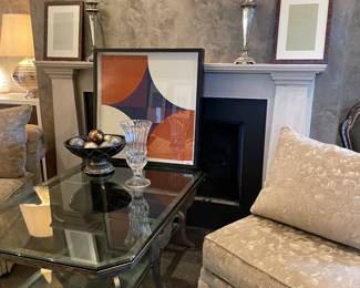 mid-modern lithograph, metal and glass cocktail table, pillar candle holders, decor,  and side chairs