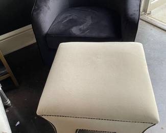 Black velvet swivel club chair and vanity bench/ottoman in ivory velvet with brass nail-head detail