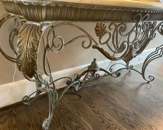 Burnished metal base of console table