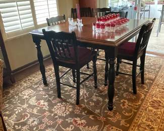 Bar height dining table with 6 chairs and an insert. 
