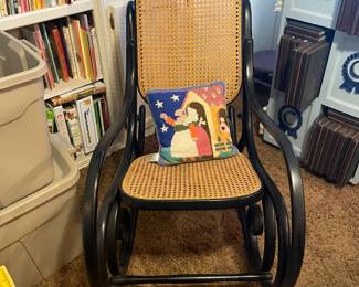 Cane and wood rocking chair.