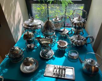 Dozens of lovely silver plate serving pieces and silverware.