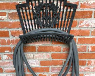 Wall mounted wrought iron hose holder