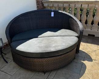 Outdoor brown wicker  sofa and ottoman 