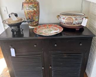 Several Chinese urns, platters, etc.  Large black side board, previously used as entertainment center.