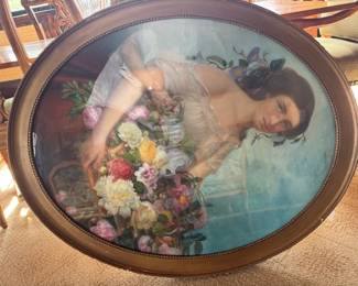 Large oval painting of woman holding flowers