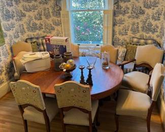 Early 1900's Oak Dining table with claw feet on table and chairs.  Has 6 leafs and expands to around 120 inches.  Chairs have a silk floral fabric on the back and are front is a champagne/tan fabric.  Very well made and sturdy.