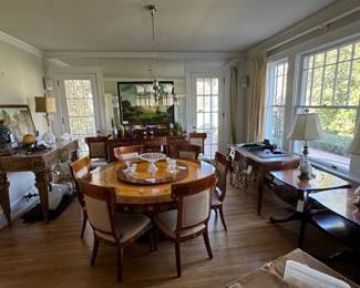 Exquisite Italian round dining table with 8 chairs.  Detailed inlay in various woods.  Purchased in NYC. Has lazy susan in the middle that is removable.  Very rare and fine piece.  Has an antique sideboard that greatly complements it on the back wall.  Beautiful marble top center table on the left side wall and large French Louis IV writing desk on the right wall.  Much more!
