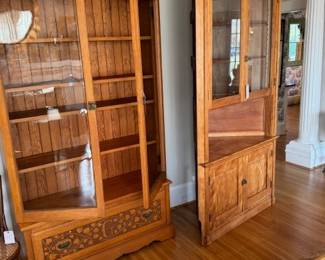Two large hutches from the Stowe Family estate in matching woods.  Appear to be made by the same person.  One is a corner hutch that has grooves for dishes.  The glass front cabinet on the left feature a "G" on the bottom drawer front.