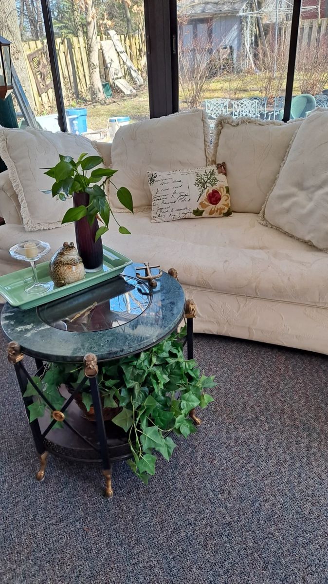 Vintage Marble, Glass & Brass Detailed Clock Table; Silk Plants; Off White Sofa and Decorative Furnishings. 