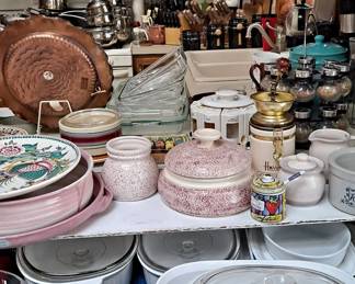 Large assortment of cookware, bake ware, serving ware, spice racks, spatter pottery, knives, glass pans... there's something for everyone and then more!!!