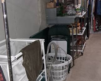 Basement Storage filled with Wheeled Shelving Units, Homes Goods & Supplies, Laundry Supplies, Card Table with Matching Folding Chairs; Men's Clothing