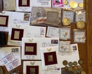 Some coins, commemorative gold pieces, an old pocket watch… close ups of all of these at the end of the pics…
