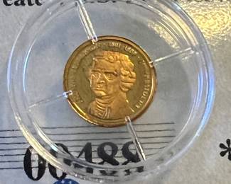 14k… uh… Jefferson maybe, or Washington, or Adam Sandler in Victorian wig… idk. It’s gold!