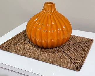 Wicker placemat,  $4.  Orange ribbed vase, 10"H,  $14