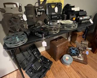 Collection of vintage projectors, cameras, and splicers. See more photos further on .